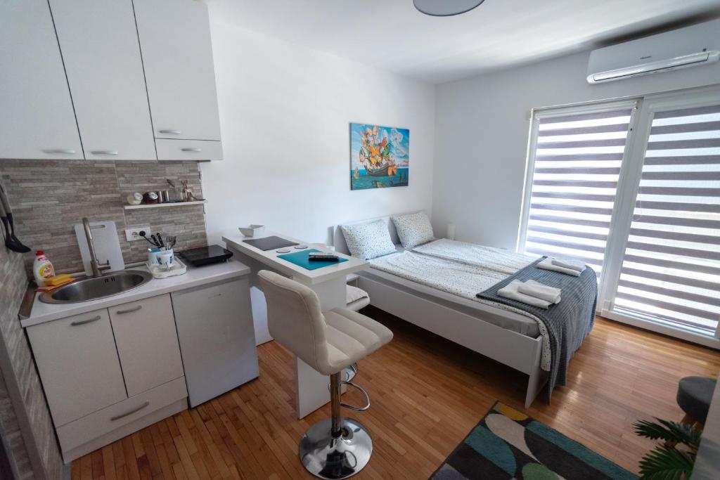 a small room with a bed and a sink at Dekart 2 in Niš