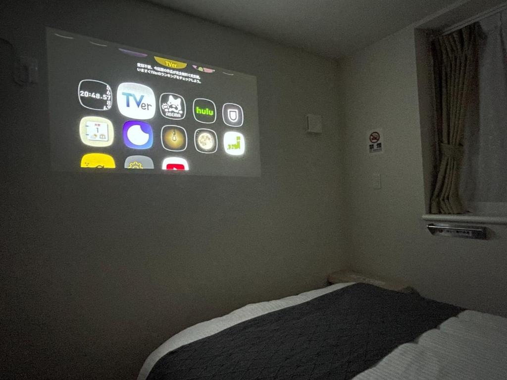 a room with a large screen on the wall at T-HOTEL Iriya - Vacation STAY 94109v in Tokyo
