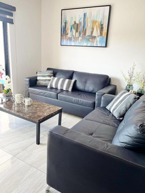 a living room with a couch and a coffee table at Marina Cerritos - Blanco Celeste - 5 Albercas in Mazatlán