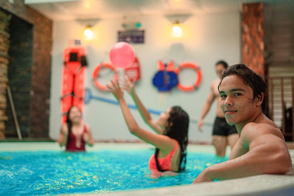 a group of people in a swimming pool at Posada Sueño Real in San Martín