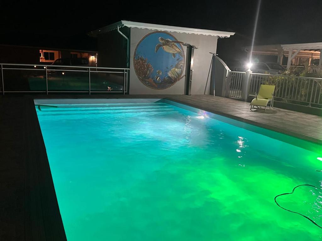 a swimming pool at night in a house at Résidence Fleur de Café - Villa 2 - La Désirade in Deshaies