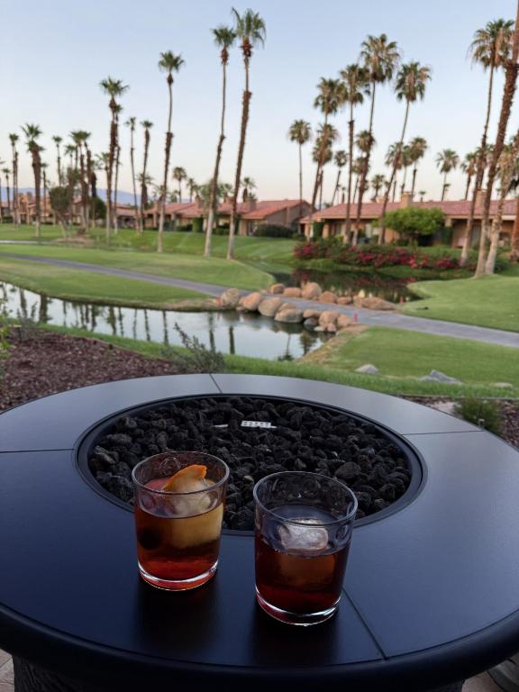 two drinks on a table with a view of a golf course at TWO Guest Suites ON Tee Box #2 Palm Valley Country Club with access to Tennis and Athletic Club Two on #2! in Palm Desert
