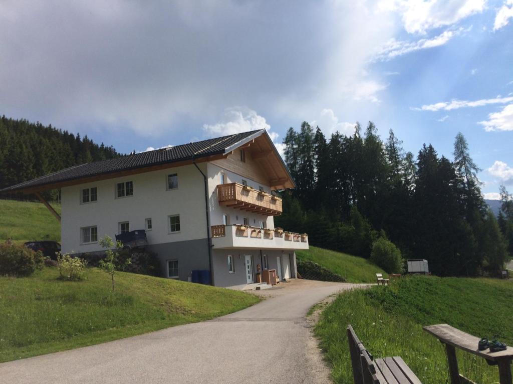 a building on a hill next to a road at Appartments Rindisplatzl in Schladming