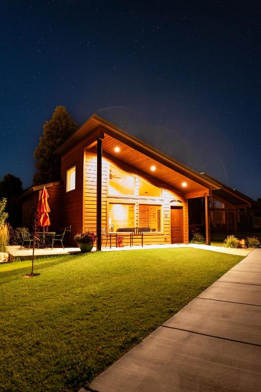 a house with a lawn in front of it at night at Bryce Canyon Inn in Tropic