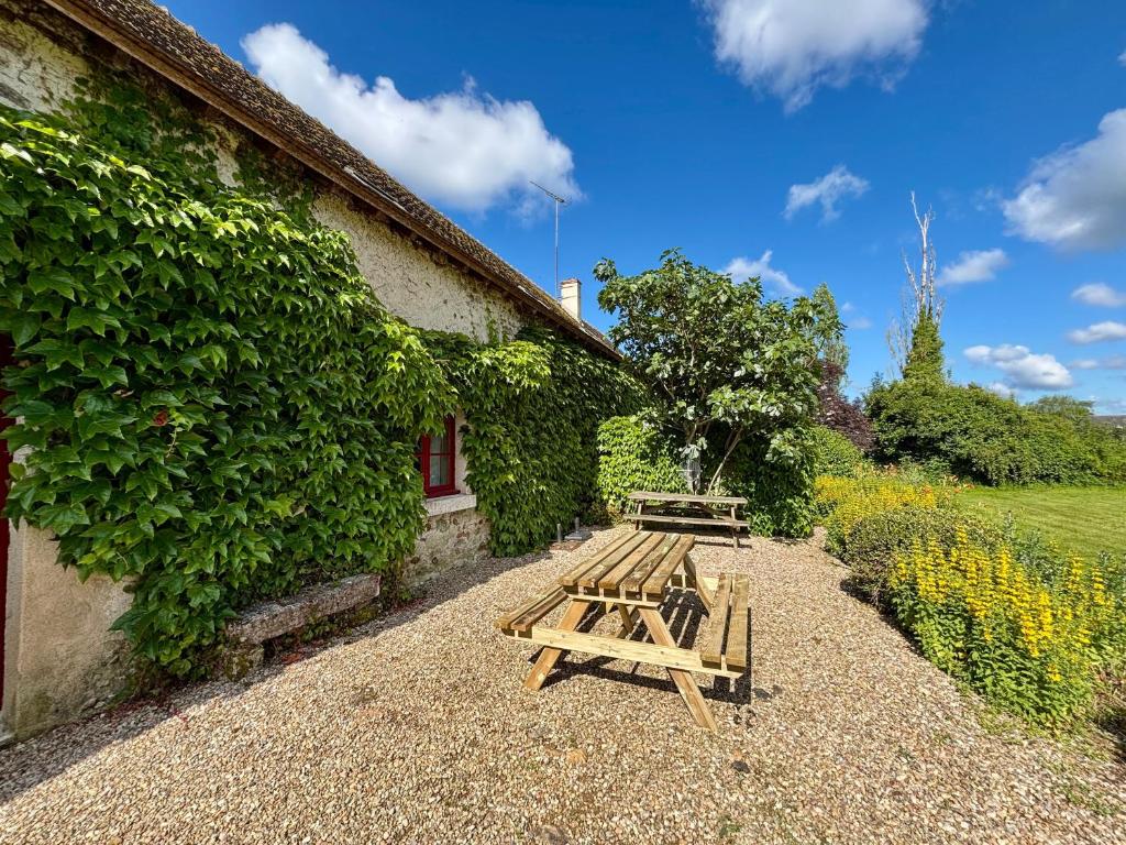 a picnic table and bench next to a building at Gîtes avec piscine partagée dans la Brenne, proche sites historiques - FR-1-591-120 in Rosnay