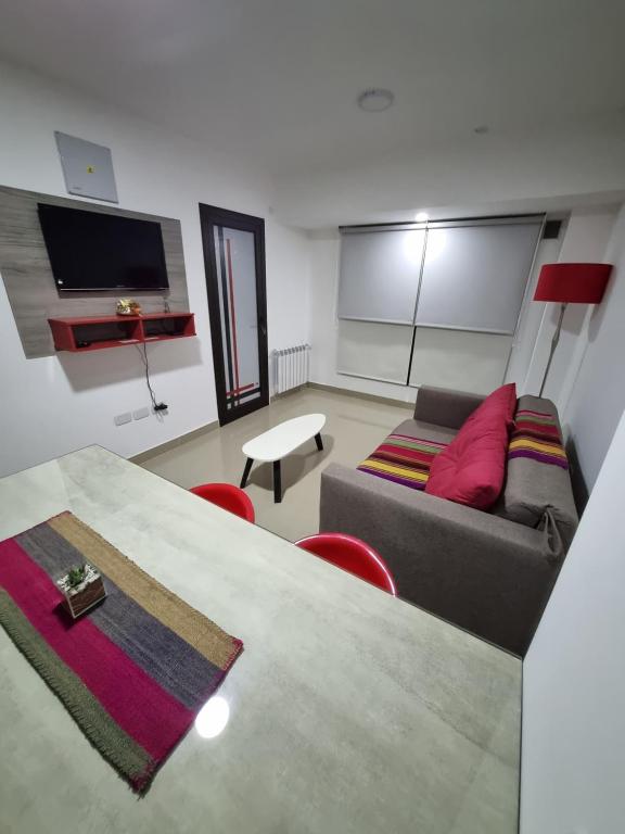 a living room with a couch and a tv at Apart dos ambientes - Macrocentro Salta in Salta