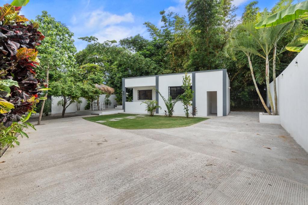 an exterior view of a white house with trees at Romantic house Bucerías Two Turtles in Bucerías