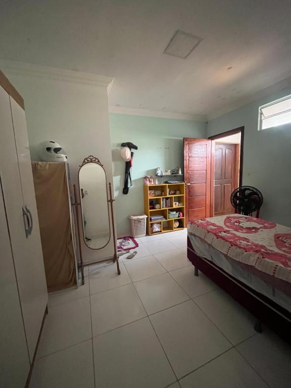 a bedroom with a bed and a mirror in it at Casa Costa in Belém