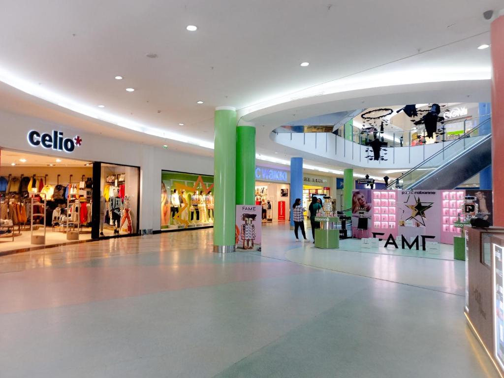 a shopping mall with people walking in the aisle at Moderne Appartement au plein Centre-Ville en Face Hilton & la Gare de Train TGV avec climatisation N2 in Tangier