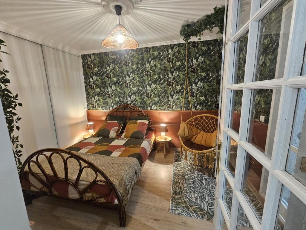 a bedroom with a bed and a swing at TropiKana in Evry-Courcouronnes