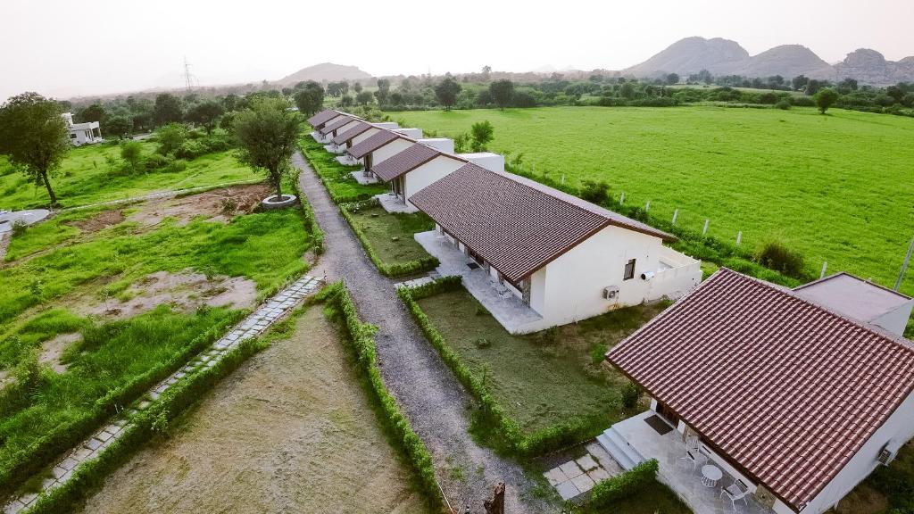 an overhead view of a row of buildings in a field at Nature Jawai Retreat in Bijāpur