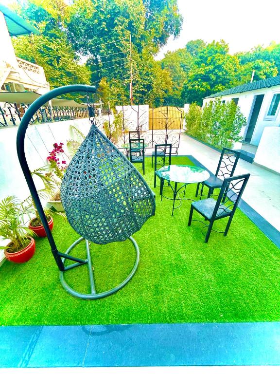 a sculpture of a bird sitting on the grass at Grand Villa in Amritsar