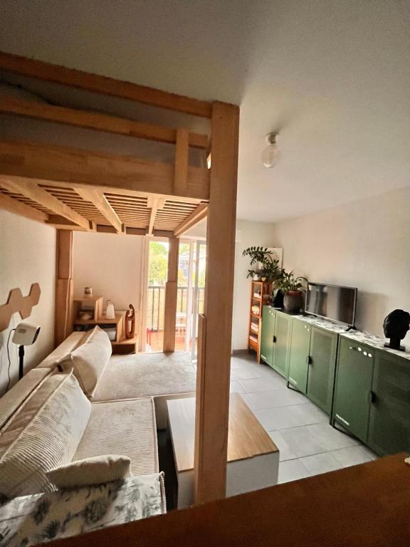 un soggiorno con divano e cucina di Appartement calme proche plage a Lanton