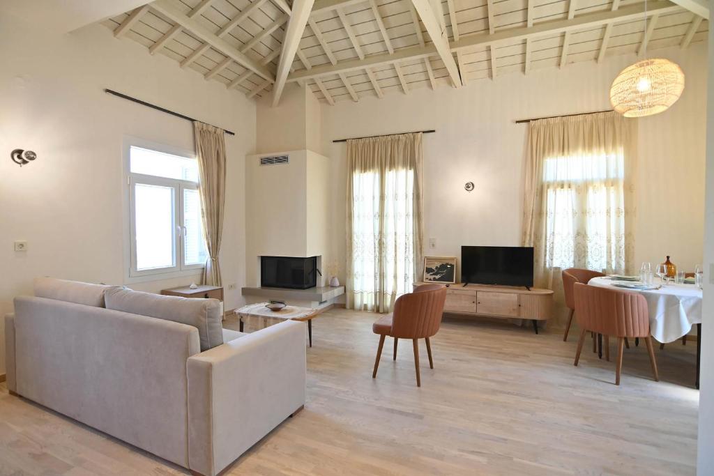 a living room with a couch and a table at Karivaliko in Vrontádos