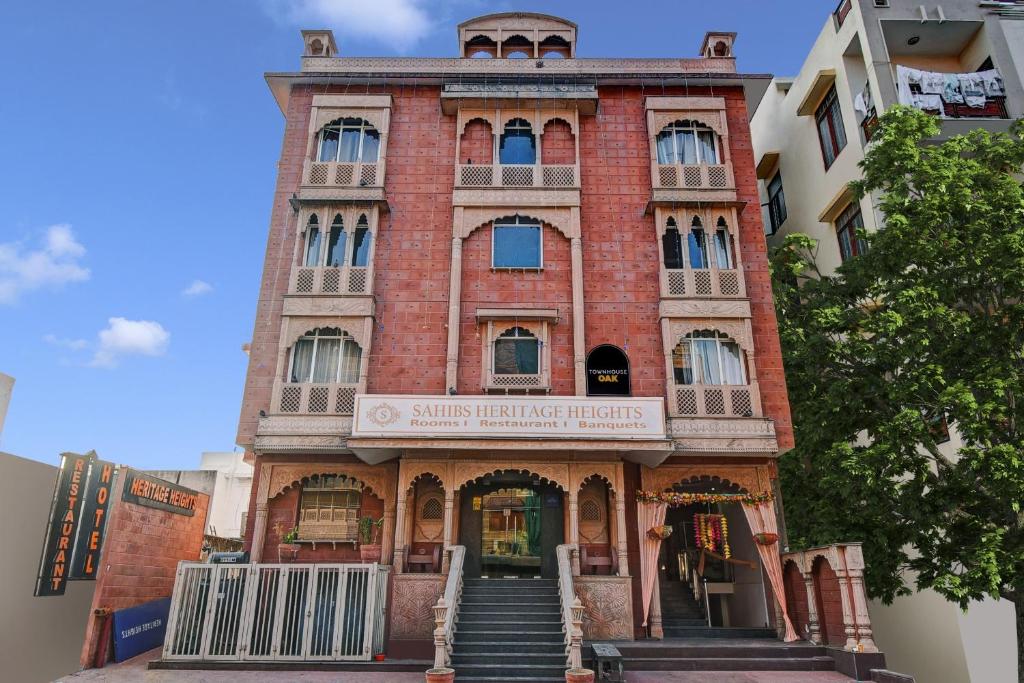 a red brick building with stairs leading up to it at Super Townhouse OAK HOTEL Heritage Heights in Jaipur