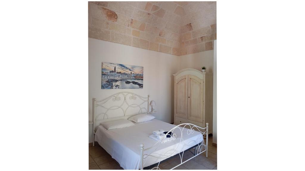 a bedroom with a white bed in a room at Masi suite in Monopoli
