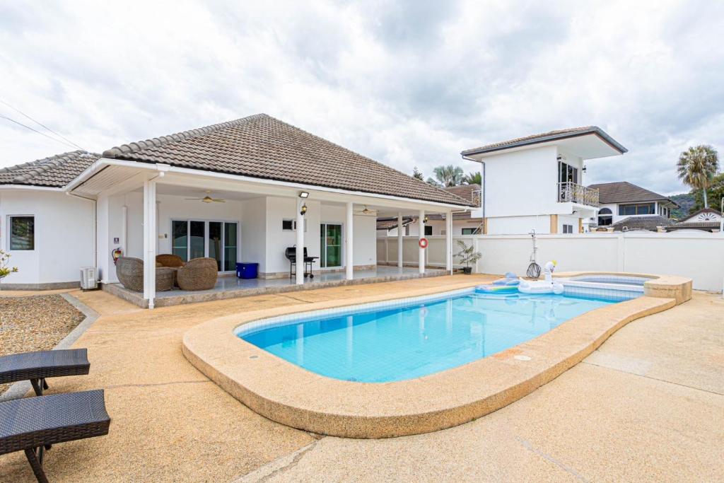 a swimming pool in front of a house at D2 Pool Villa in Hua Hin