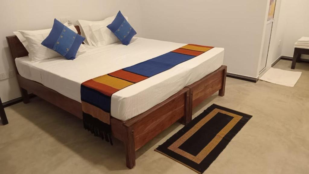 a large bed in a room with at Cinnamon Eye in Habarana
