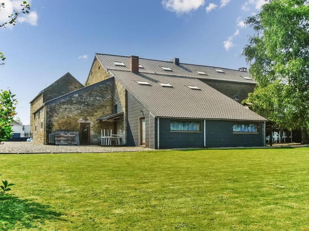 a large brick house with a large yard at Grand Family Farmhouse in Anthisnes in Anthisnes