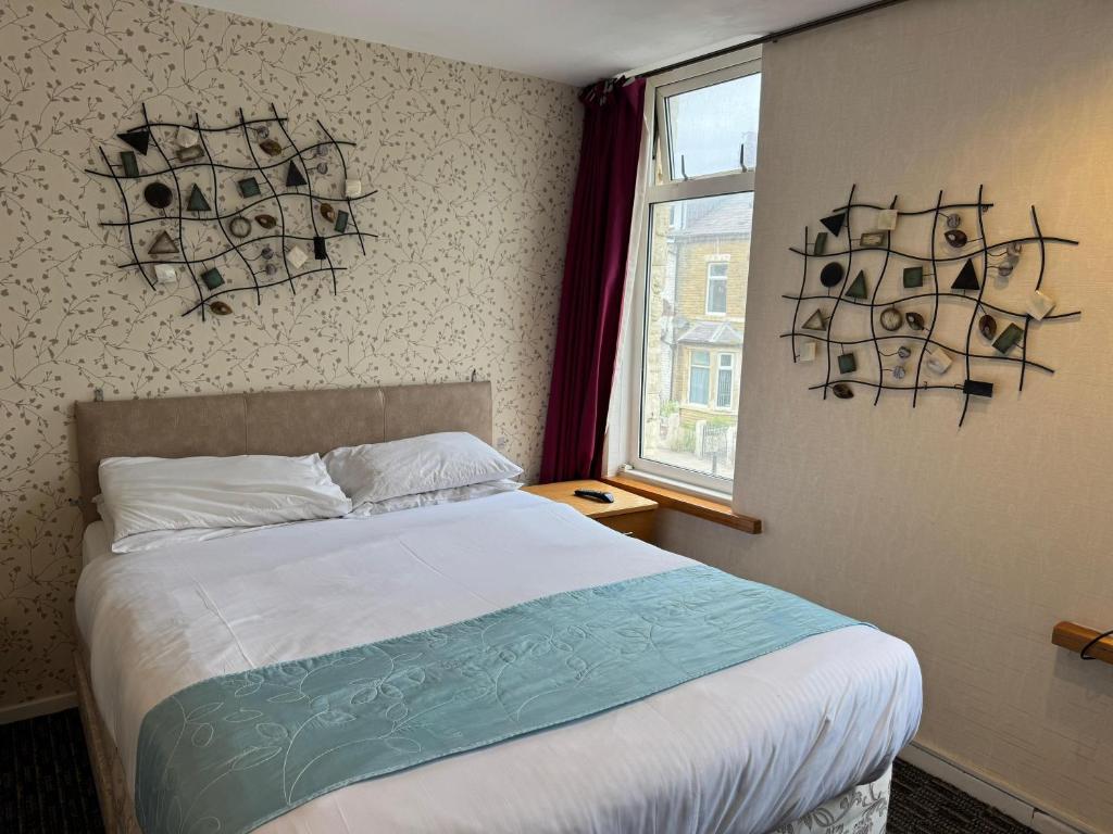 ブラックプールにあるThe Clarendon Hotelのベッドと窓のある寝室