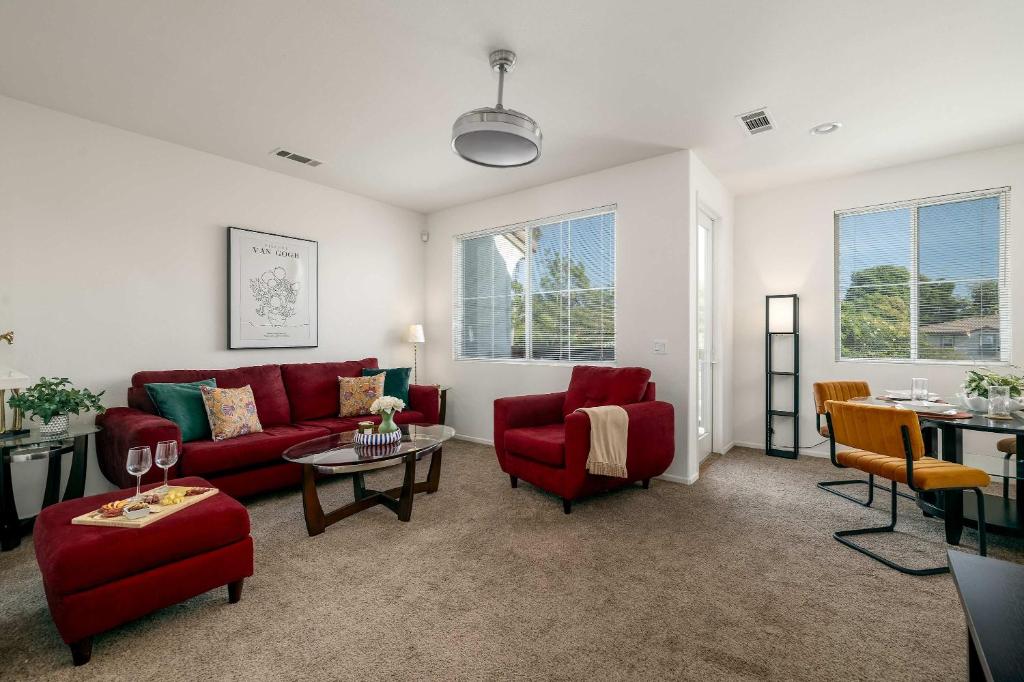 a living room with a red couch and chairs at Redecorated - Serene- Legoland- Family-Friendly in Carlsbad