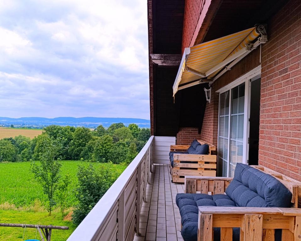 a balcony with blue cushioned chairs on a house at Glühwürmchen in Hameln