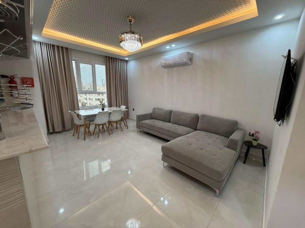 a living room with a couch and a table at new Salalah apartment in Salalah