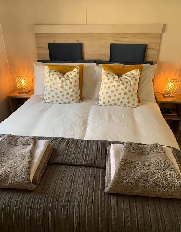a large bed with two pillows on top of it at Larch View in Tattershall