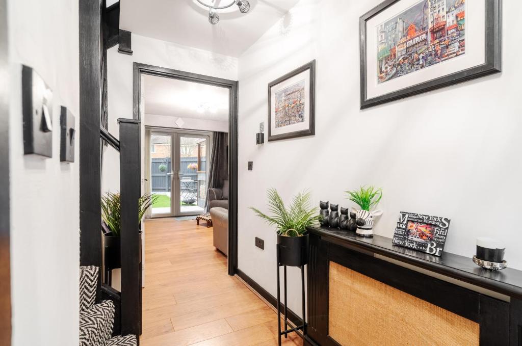 a hallway with a living room with white walls at 2 Bedroom Home with Garden and Free Parking in Litherland