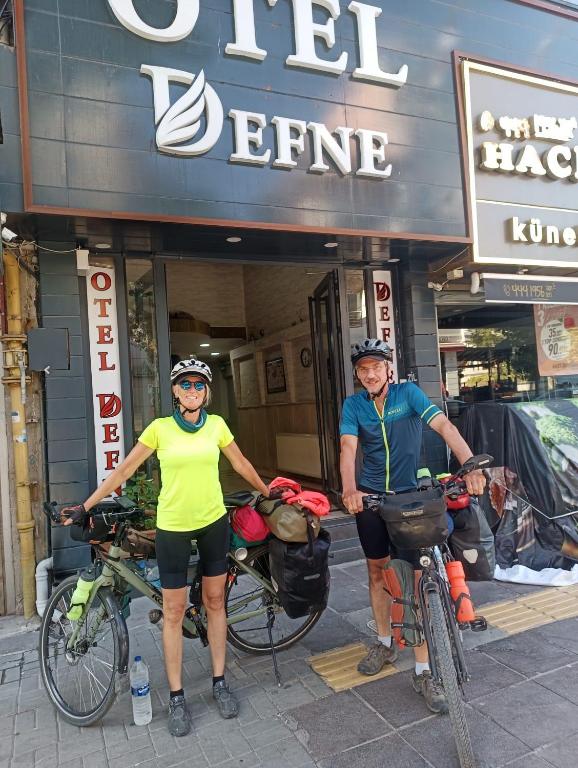 two people with their bikes in front of a store at OTEL DEFNE in Polatlı