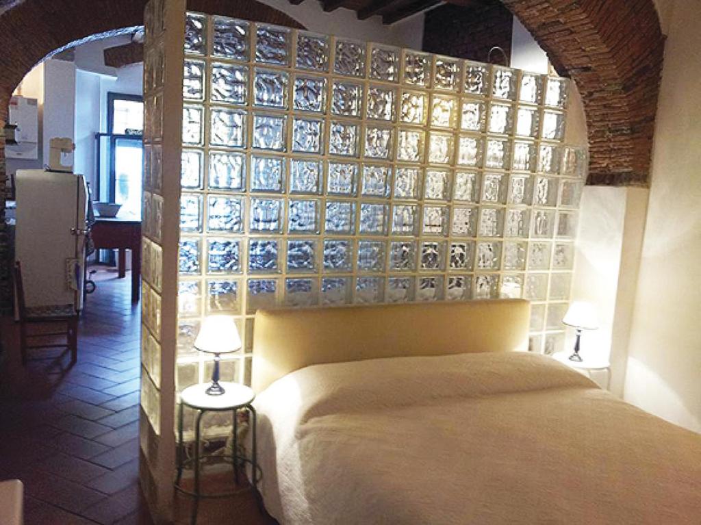a bedroom with a large bed with a glass wall at Real Taste of Tuscany in Florence