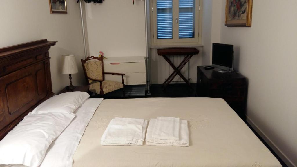 a bedroom with a bed with two towels on it at Il Conventino Appartamento in Osimo