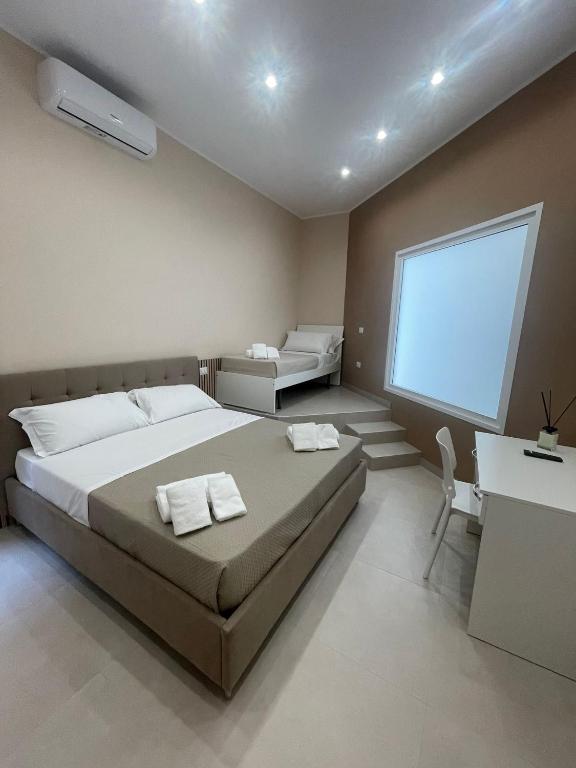 a bedroom with a large bed and a window at Catapano's House in Pompei