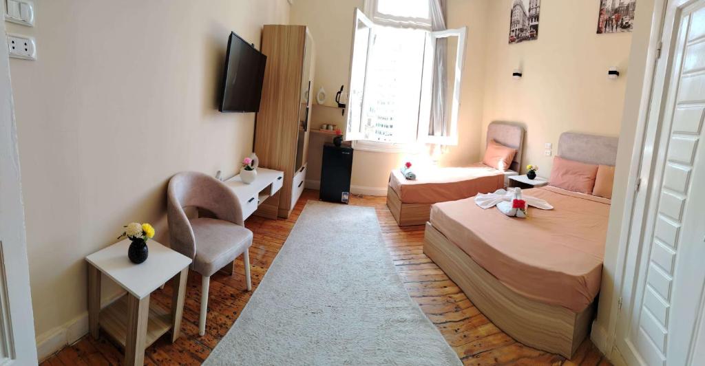 a small bedroom with a bed and a couch at Tahrir Palace in Cairo