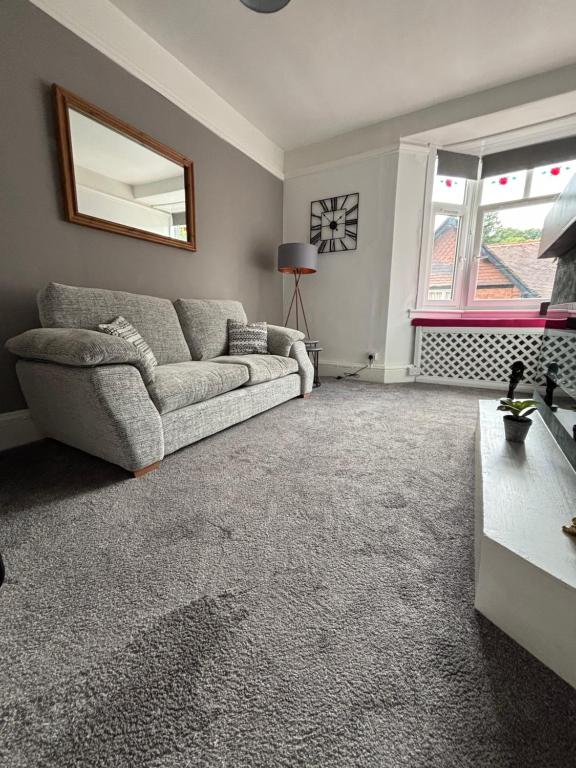 a living room with a couch and a window at Church Stretton Shropshire Hills in Church Stretton
