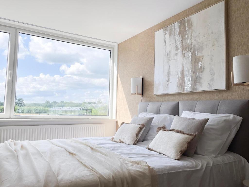 a bedroom with a bed with a large window at New Bed-room, Nature Location,university Tilburg in Tilburg