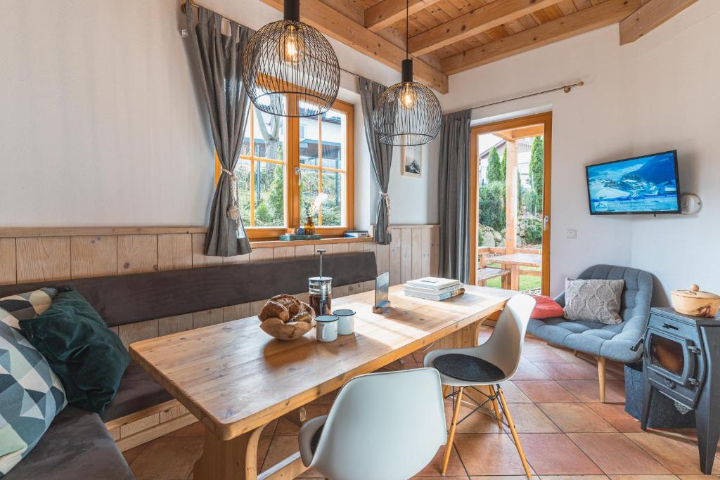 a living room with a wooden table and chairs at Dorfchalets - Chalet Cenzi inkl Tauern Spa Eintritt & Sommerkarte in Kaprun