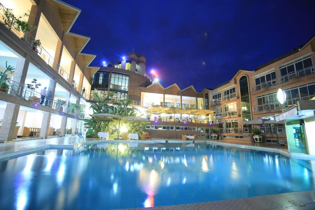 a large swimming pool in a building at night at Lemigo Hotel in Kigali