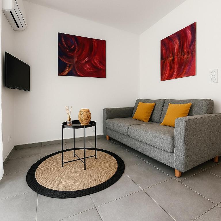a living room with a couch and a table at Résidence Arborea C4 corte in Corte