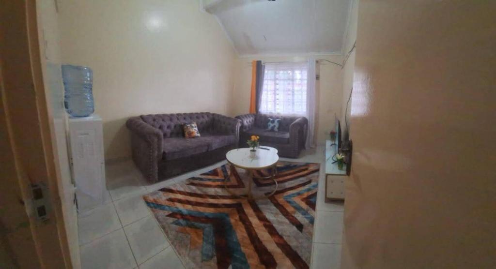 a living room with a couch and a table at Two Bedroom Guest House in Nairobi