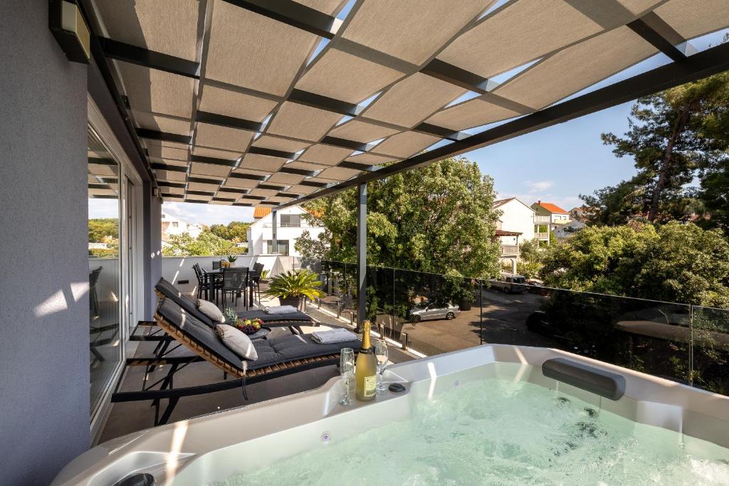 a jacuzzi tub on the balcony of a house at La Perla - Korčula in Korčula