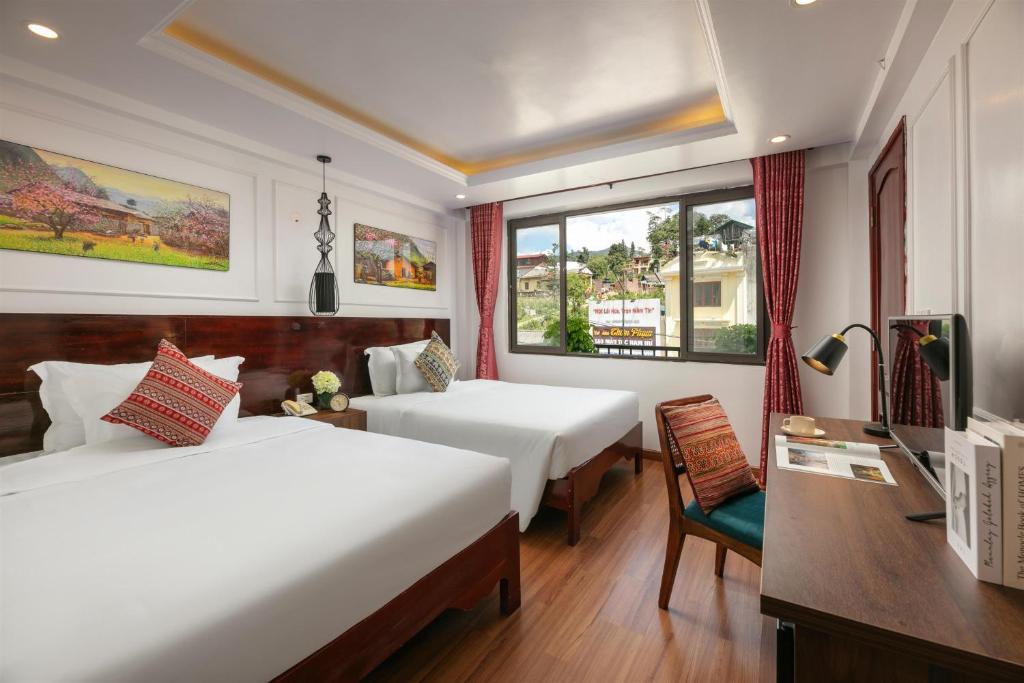 Giường trong phòng chung tại Glow Sapa Hotel