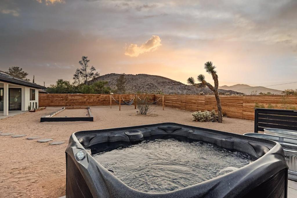 a hot tub in the middle of a yard at Moon Dusk By The Cohost Company in Joshua Tree
