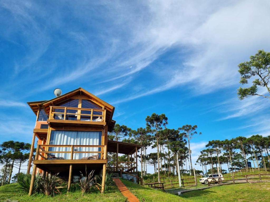 a tree house in the middle of a field at Cabana Araucária in Bom Retiro