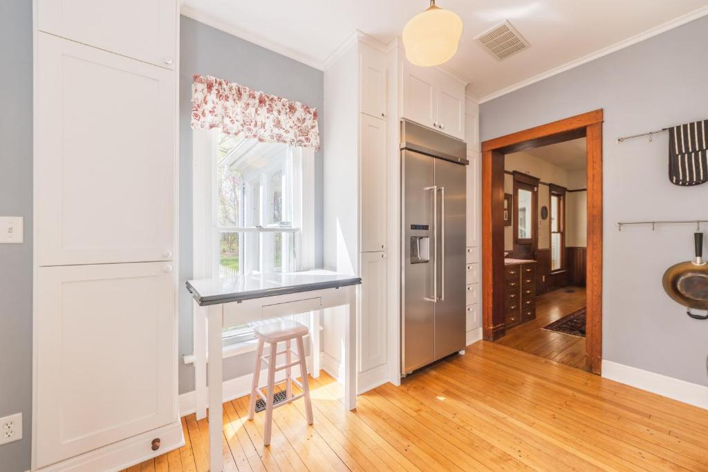 a kitchen with white cabinets and a counter and a window at Elsie in Benton Harbor