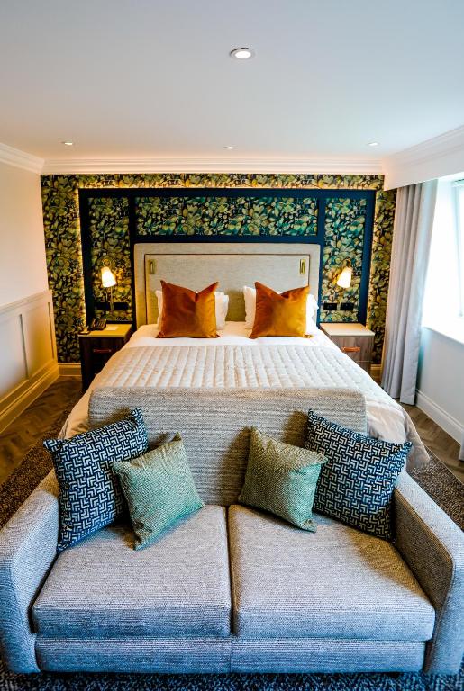 a bedroom with a large bed and a couch at Gretna Hall Hotel in Gretna Green