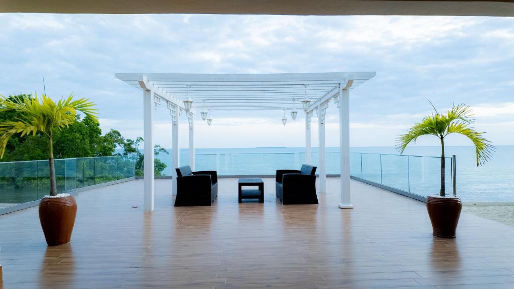 a pavilion with chairs and a view of the ocean at Golden Palm Boutique Zanzibar in Zanzibar City