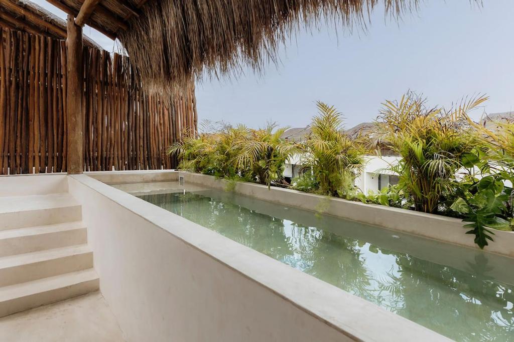 a swimming pool in the middle of a resort at Itzel Samsara Dream Penthouse in Tulum