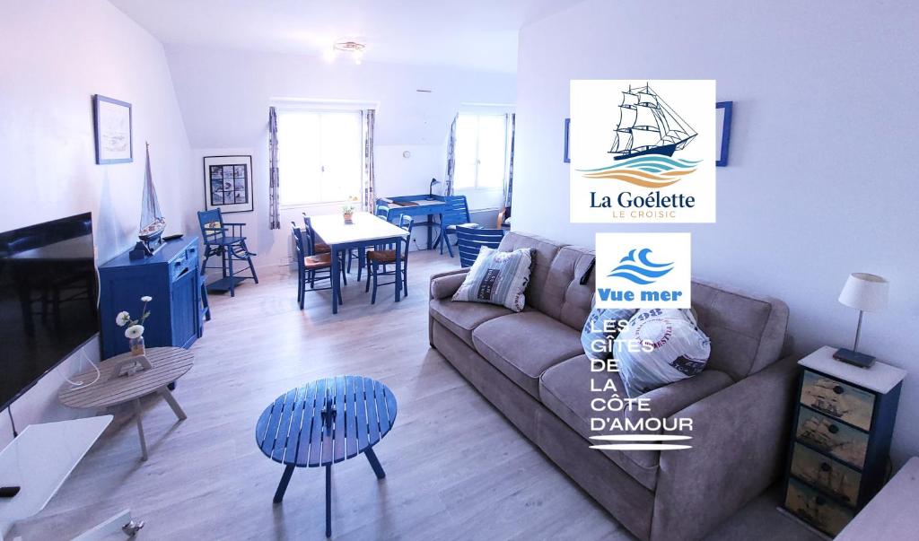 a living room with a couch and a table at La goélette - Les Gîtes de la Côte d'Amour in Le Croisic