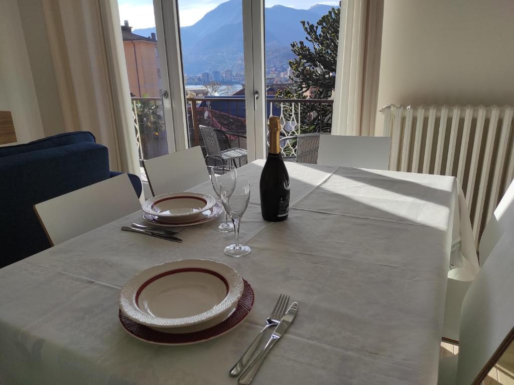 a dining room table with a bottle of wine on it at Residenza Gattoni in Omegna